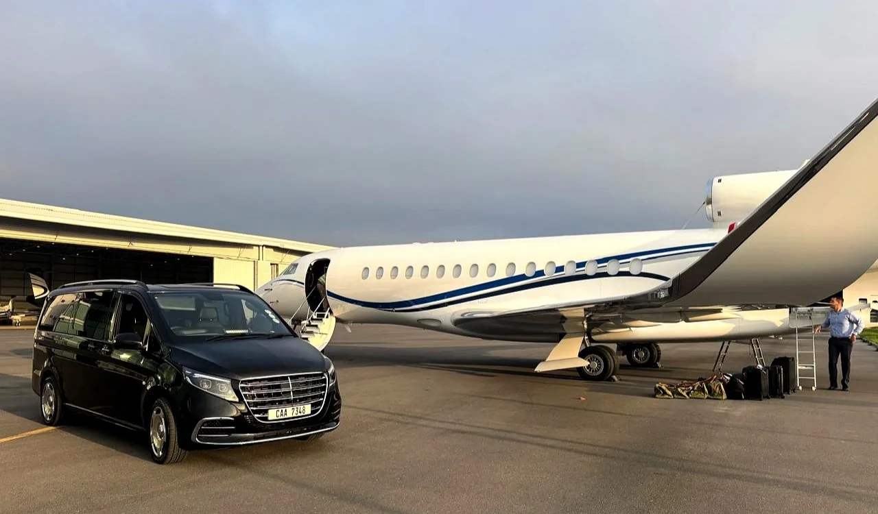 A sleek Black Mercedes Benz luxury minivan parked at private airport terminal in Cape Town