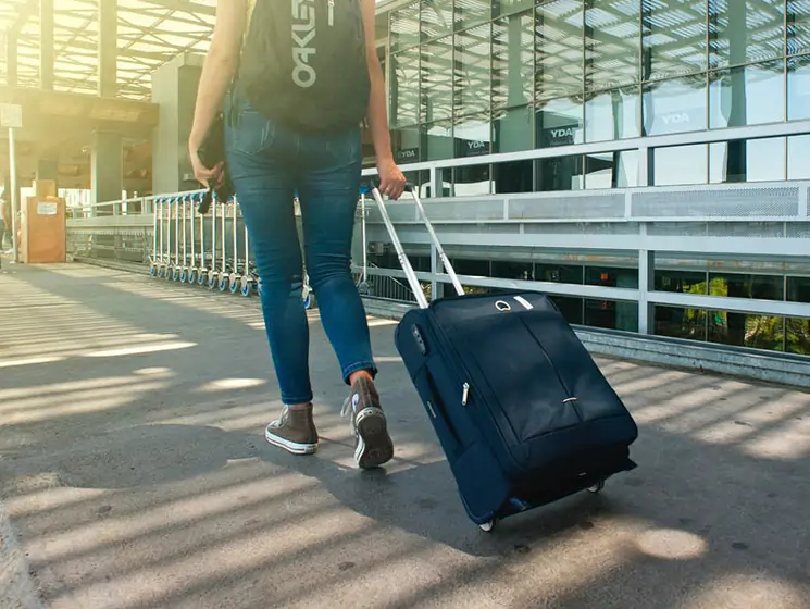 Woman pulling luggage at cape town international airport